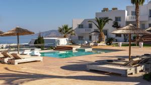a resort with a pool and chairs and umbrellas at Arkasa Palace in Arkasa +37 photos