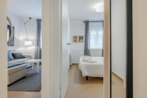 a living room with a couch and a mirror at Inside Barcelona Apartments Salva in Barcelona