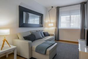 a living room with a couch and a window at Inside Barcelona Apartments Salva in Barcelona