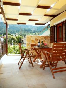a patio with a table and chairs and a view at Portico Cozy Home in Kariá