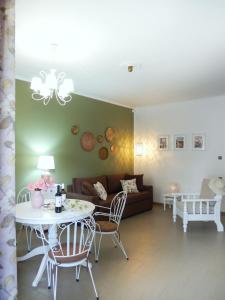 a living room with a table and a couch at Portico Cozy Home in Kariá