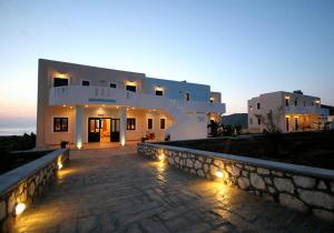 a large white building with lights in front of it at Archipelagos Apartments in Arkasa