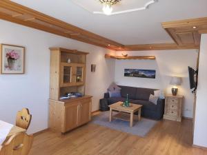 a living room with a couch and a table at Apartmenthaus WALDHORN in St. Wolfgang