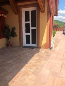 a door to a house with a patio at Casa Alexia in Haţeg