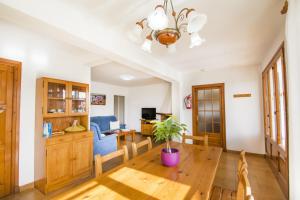 a living room with a wooden table and a dining room at Miramar K by Sonne Villas in Cala Galdana