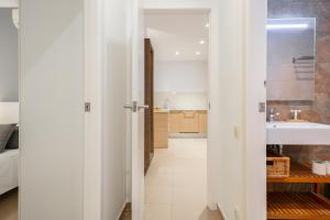 a white bathroom with a sink and a mirror at Inside Barcelona Apartments Salva in Barcelona