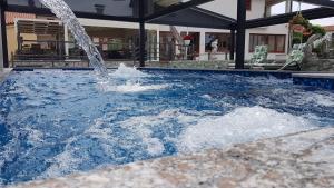 a fountain in a pool with blue water at Villa Vista 1 in Malinska +29 photos