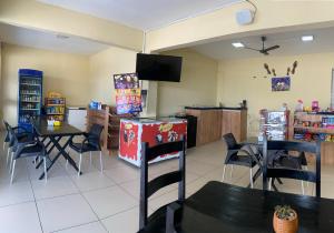 a dining room with tables and chairs and a tv at Pousada Sertaneja in Canindé de São Francisco +15 photos