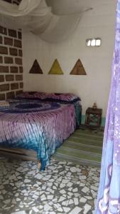 a bedroom with a bed in a tent at Chez Bethy Jungle et Océan in Abene