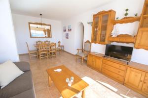 a living room with a couch and a table at Collmar by Sonne Villas in Cala Galdana