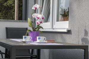 uma mesa com dois copos e um vaso com flores em Holiday Home Sea em Premantura