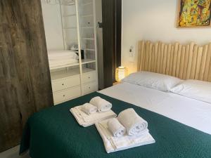 a bedroom with a bed with towels on it at Le Casuzze Ammare in Favignana