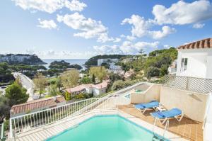 a view from the balcony of a house with a swimming pool at Casa Febrer by Sonne Villas in Cala Galdana
