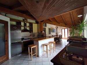 a kitchen with a counter and some chairs in it at Chalet Lullaby in Fiumenero