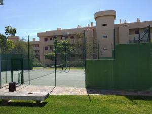 a couple of tennis courts with a green fence at Alamar Mijas Sweet Apartament in Málaga