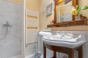 a bathroom with a sink and a shower and a mirror at Fattoria la Gigliola - La Torre in Montespertoli +11 photos