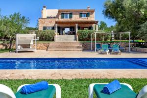 a villa with a swimming pool and a house at Bassa Seca mit Pool und Wifi in Santanyi