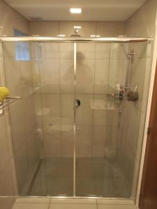 une douche avec une porte vitrée dans une salle de bain dans l'établissement Casa Perez, à San Martín de los Andes
