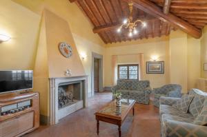 ein Wohnzimmer mit einem Kamin und einem TV in der Unterkunft Fattoria la Gigliola - La Terrazza in Montespertoli