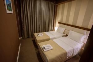 Postel nebo postele na pokoji v ubytování Apart Hotel West