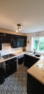 a kitchen with a sink and a stove top oven at The Roman Retreat in Chester