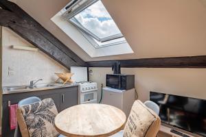 a kitchen with a table and a skylight at Heaven - GOLDEN TREE - WIFI - 20 min St-Croix & Center Parcs in Sarrebourg