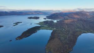 an island in the middle of a body of water at Steading Cottage - 50m from the beach in Port Appin