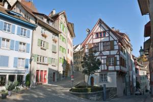 a street in a medieval town with buildings at Hotel du Parc Baden in Baden