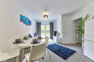 a dining room with a white table and chairs at Low Lights - Properties Unique in North Shields