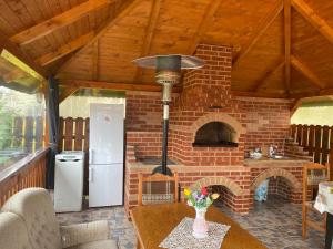 a kitchen with a brick oven in a house at Casa Alexia in Haţeg