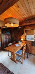 a wooden table in a room with a kitchen at Chalet Nature in Thollon