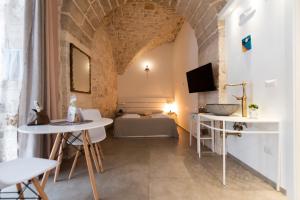 a living room with a table and a couch at Il Saraceno Apartment in Giovinazzo