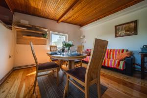 a dining room with a table and chairs and a couch at Kuća za odmor Activ in Sveti Ilija