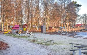 a park with a playground with benches and trees at Stunning Apartment In Sölvesborg in Sölvesborg