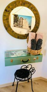 a mirror on a wall with a table and a mirror on a shelf at Apartamento T1 no centro TÊ-U in Torres Vedras