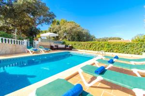 einen Pool mit Liegestühlen und einem Pool in der Unterkunft Villa Ohana by Sonne Villas in Cala Galdana