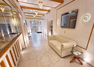 a living room with a couch and a table at Gesundheitshotel Rössle in Bad Wurzach +20 photos