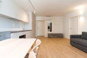 a kitchen and living room with a table and a couch at Premium Tartini Apartment 2 by Locap Group in Piran