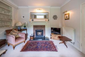 a living room with a couch and a fireplace at Pelham Grove in Shrewsbury