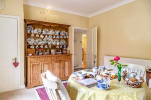 a dining room with a table and plates on a wall at Pelham Grove in Shrewsbury