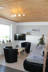 a living room with a table and chairs at Lro in Stäbelow