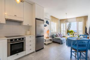 a kitchen with a stove and a table in a room at 1- Bedroom Apartment near Meneou Beach in Larnaka