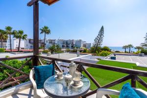 a balcony with a table and chairs and the ocean at 1- Bedroom Apartment near Meneou Beach in Larnaka