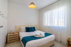 a bedroom with a bed with blue and white at 1- Bedroom Apartment near Meneou Beach in Larnaka