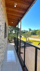 a balcony with a fence and a view of a field at Hiraya Apart in Puerto Iguazú