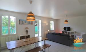 a living room with a couch and a table at Duplex au coeur du Port d'Hyères- Plages Parking BY HC in Hyères