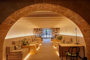 an archway in a room with couches and tables at Fil Suites in Palma de Mallorca