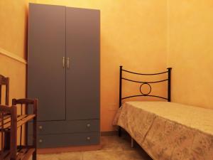 1 dormitorio con 1 cama y vestidor junto a un armario en Casa Vacanze da Antonio, en Torre Lapillo