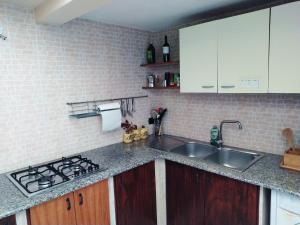 a kitchen with a sink and a stove at Casa Vacanze da Antonio in Torre Lapillo