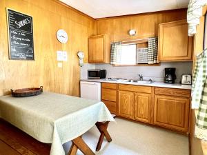 a small kitchen with a table and a sink at Willow Springs Resort in Bridgeport